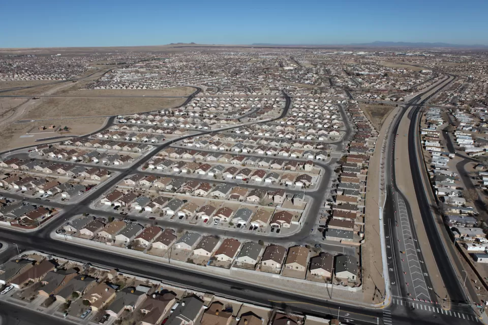 A spraling subdivision of single-family detached housing in a desert setting.